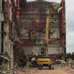 A large building being mechanically demolished