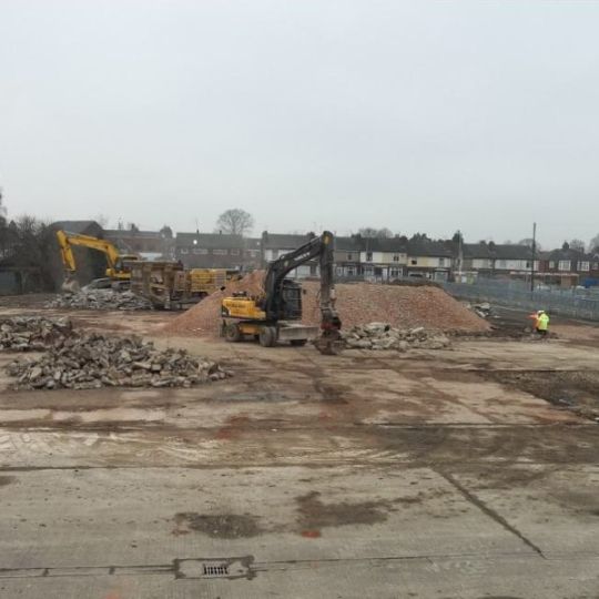 Heavy equipment moving & sorting rubble at a demolition site