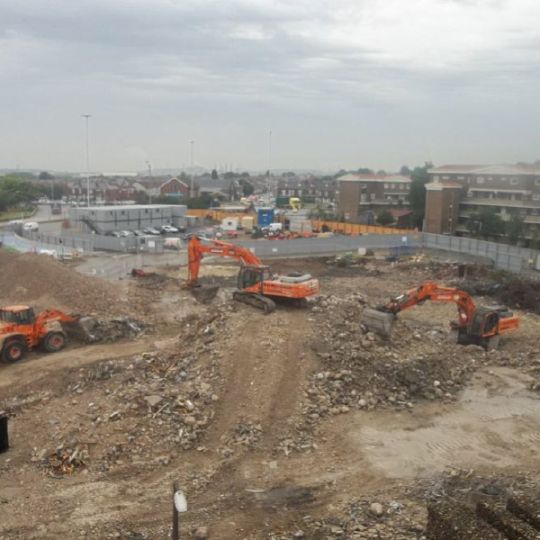 Diggers clearing rubble from a demolition site