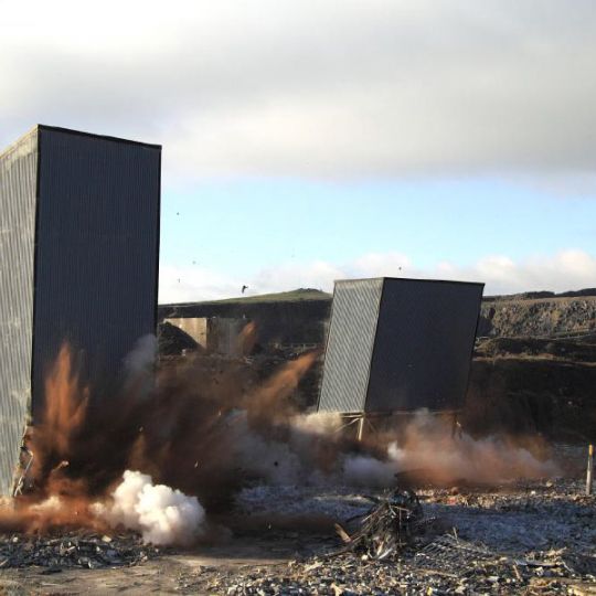 Structures mid collapse in demolition