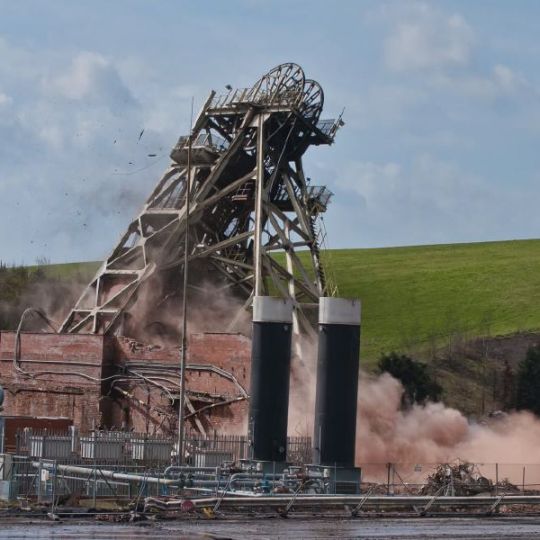 Head gear pulley mid-collapse during mine demolition